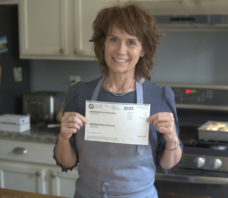 Lise holding her business license