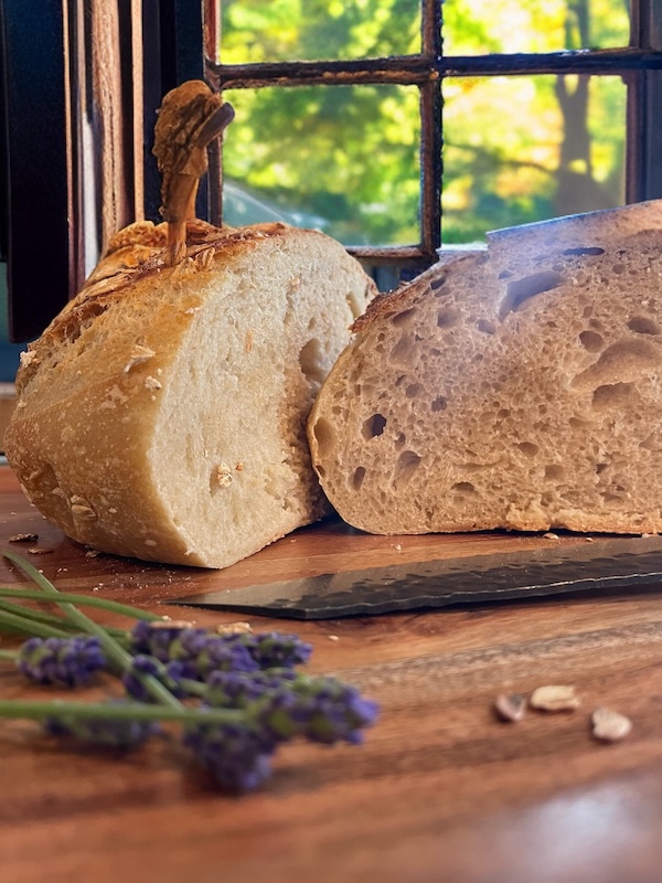 Sliced sourdough loaf on wooden board